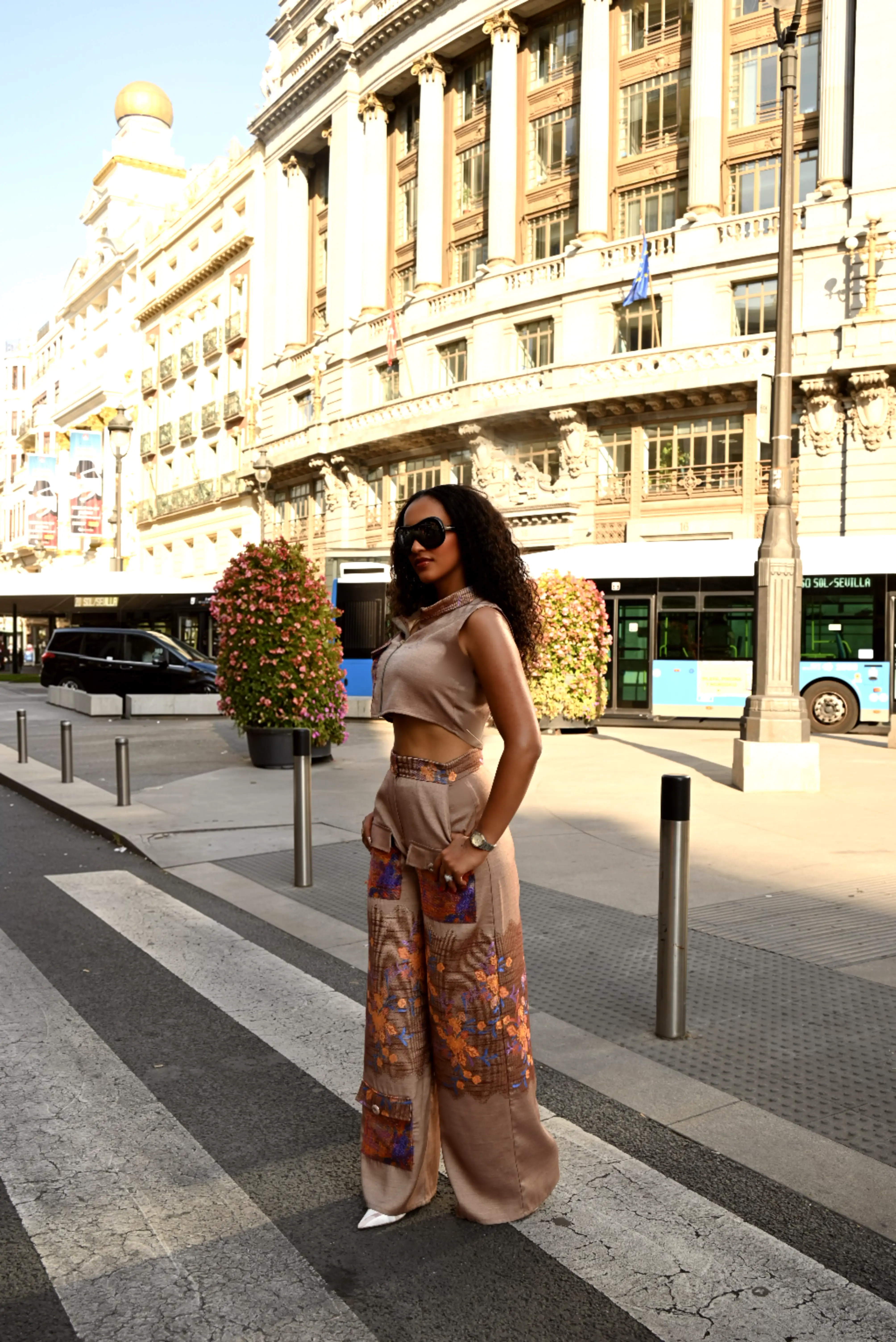 Model wearing Urban Bloom on a city crossing in golden afternoon light